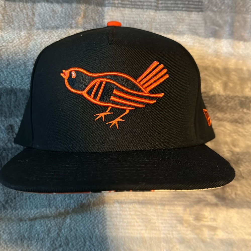 New era Baltimore Orioles hat. Black adjustable with flower pattern.